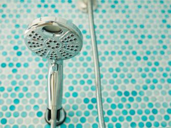 Chrome Showerhead in Blue Tiled Shower