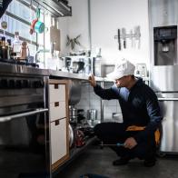 Plumber analyzing kitchen sink